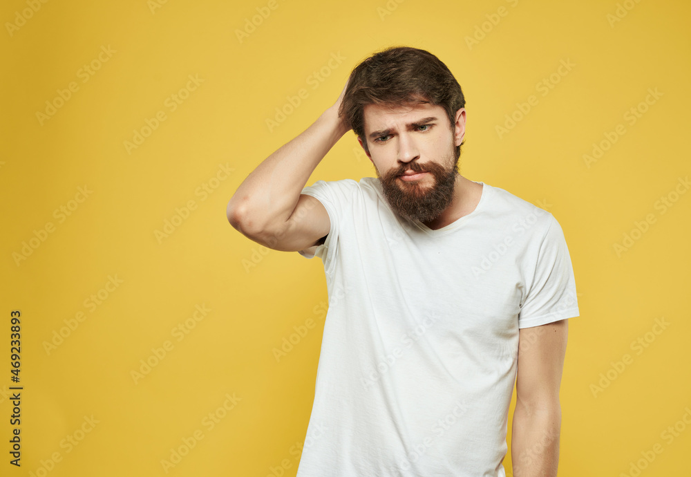 bearded man in a white t-shirt serious look close-up bearded man in a white t-shirt serious look close-up