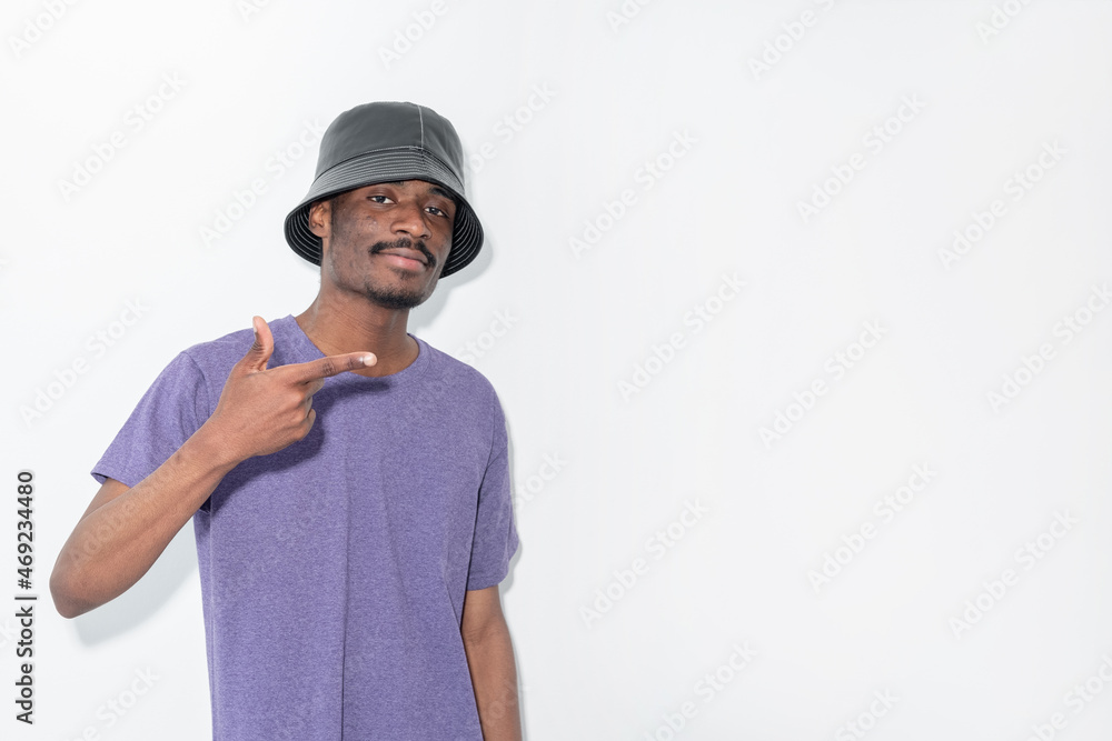 Urban fashion. Hip-hop man. Advertising background. Stylish hipster guy in leather hat pointing copy space isolated white. Urban fashion. Hip-hop man. Advertising background. Stylish hipster guy in leather hat pointing copy space isolated white.