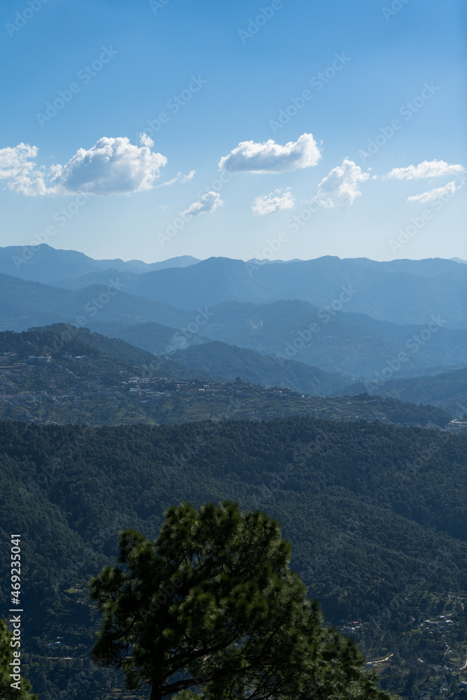 view of almora city from kesar devi on a bright sunny day
