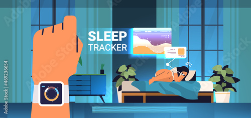 young woman sleeping in bed with electronic smart watch app tracker on hand quality and quantity sleep control