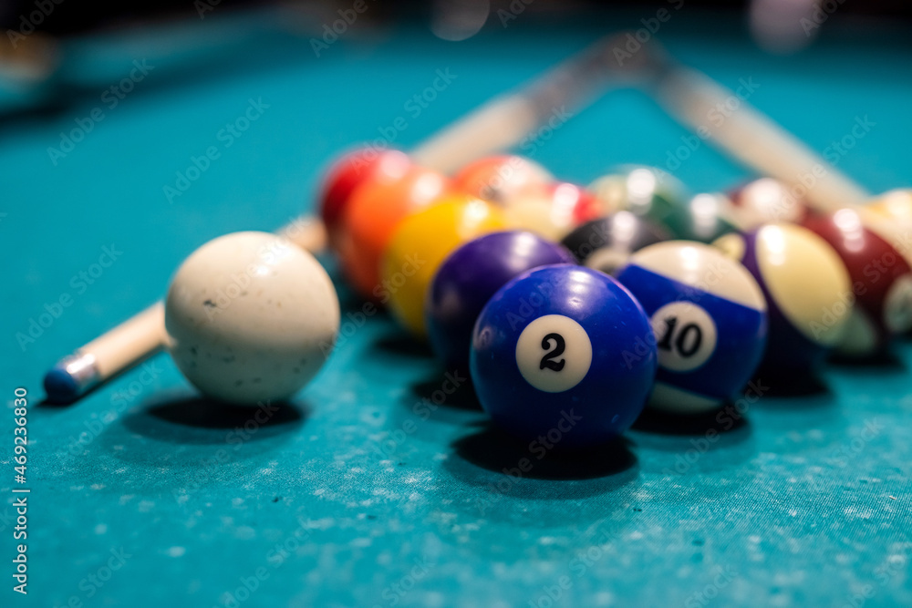 Billiard balls in a green pool table, ready for recreational activity Billiard balls in a green pool table, ready for recreational activity