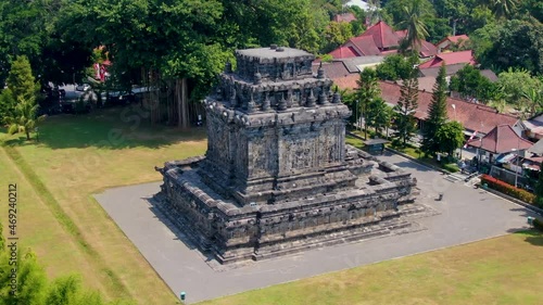 Majestic historical stone building of Mendut temple, aerial orbit view photo