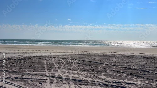 Tire Tracks on the Beach looking Out to the Ocean