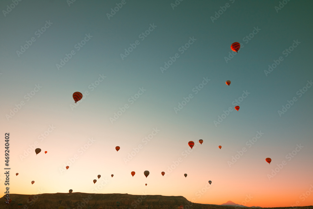 Hot air balloons at sunrise. Sunrise in Cappadocia with hot air balloons on sky