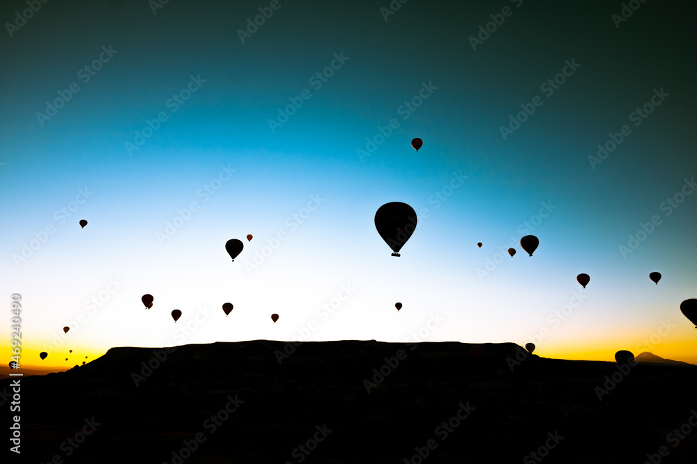 Hot air balloons silhouette. Cappadocia hot air balloons at sunrise on the sky.