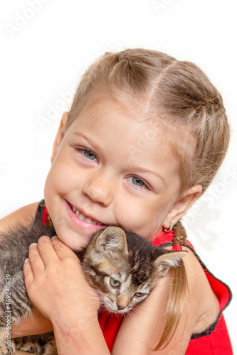 Isolated little girl holding kitten on white background