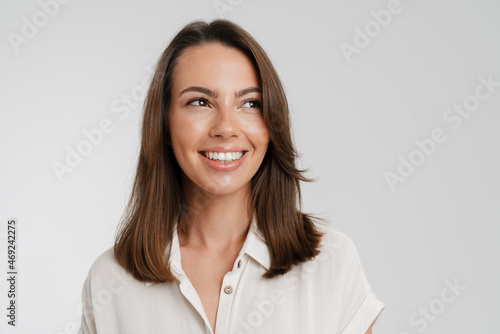 Young european woman in shirt smiling and looking aside