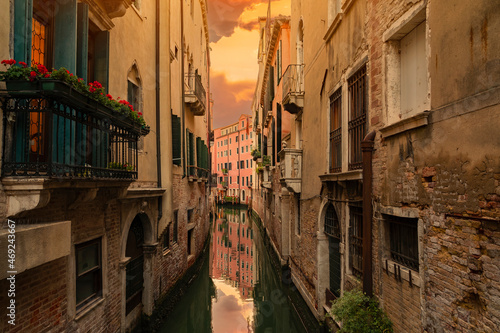 Canal with boats in Venice, Italy.