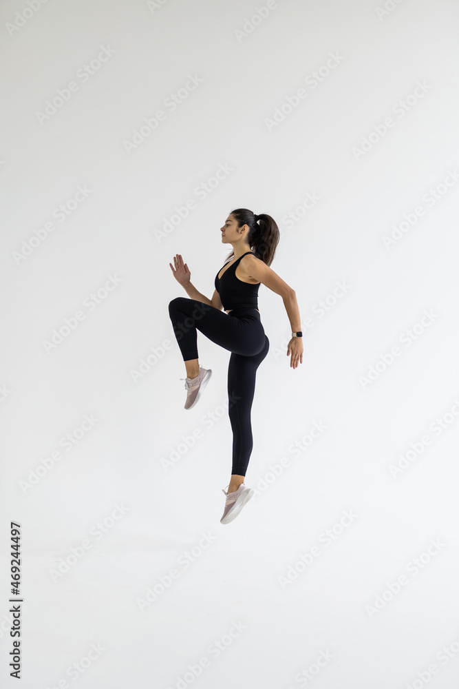 Fototapeta premium Fitness woman aerobics. Fresh energetic female fitness instructor doing aerobics.