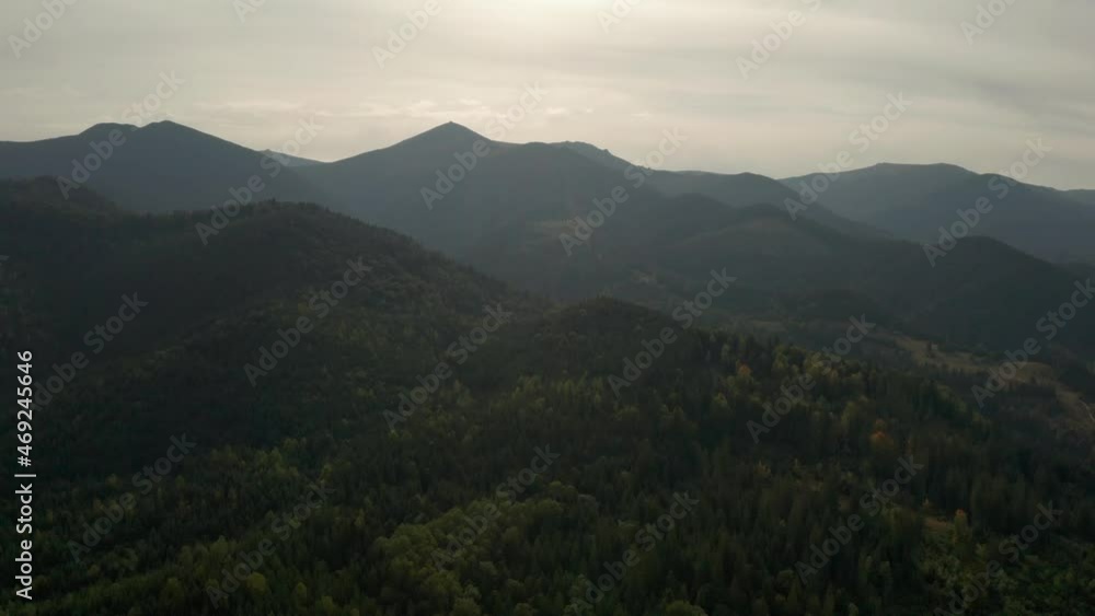 Picturesque view of mountains covered with woods. Drone flying forward over peaks Picturesque view of mountains covered with woods. Drone flying forward over peaks