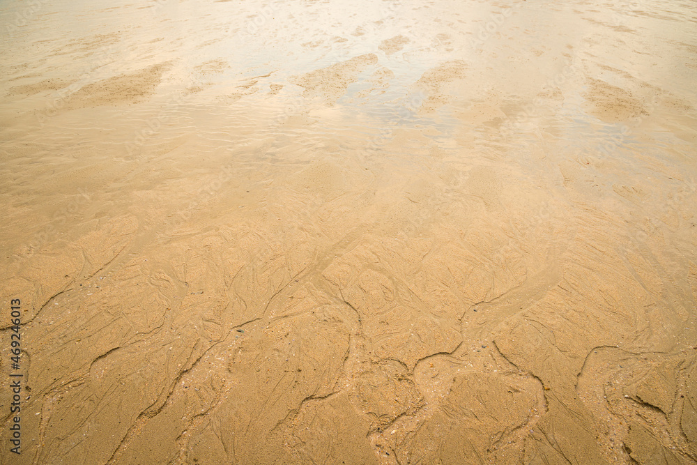 Water erodes the sand on the beach Water erodes the sand on the beach