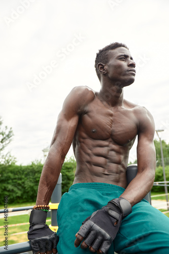 African man smiling after workout. He is in a park.