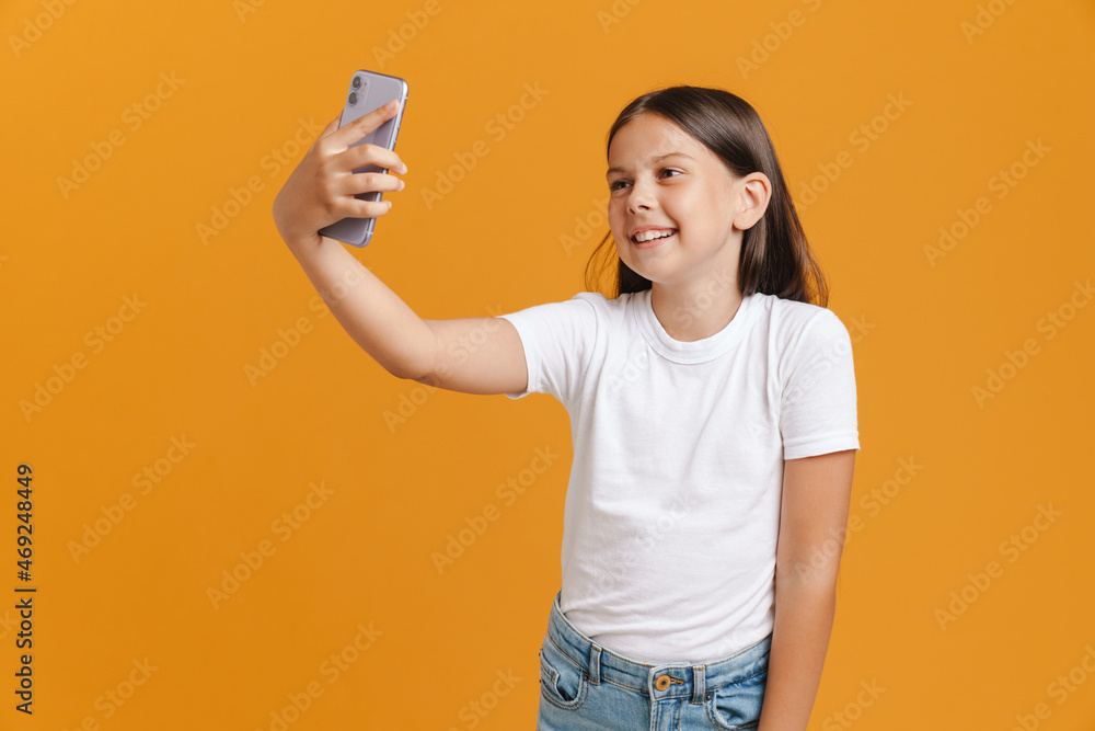 White brunette girl smiling while taking selfie on mobile phone White brunette girl smiling while taking selfie on mobile phone