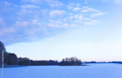 Frozen lake and forest. Winter landscape. 