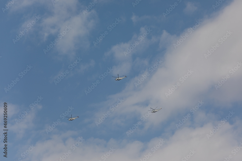Fototapeta premium planes and helicopters crossing the sky during a military parade in Madrid
