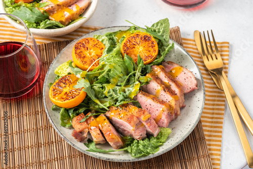 Salad with roasted duck breast and grilled orange tangerines. Natural organic nutrition.
