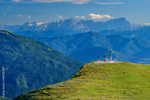 Woman standing at mountain edge in Carinthia, Austria photo