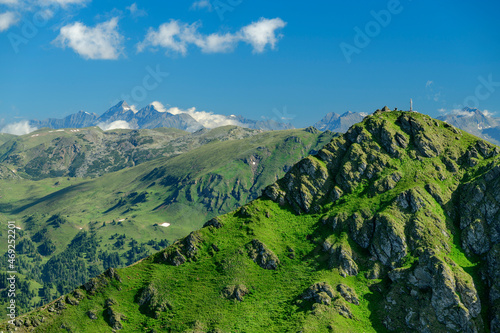 Sunlight on green mountains under sky at Carinthia, Austria photo
