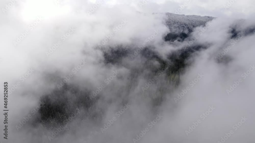 Flying through the clouds over a fresh snow covered forest in Oregon Flying through the clouds over a fresh snow covered forest in Oregon