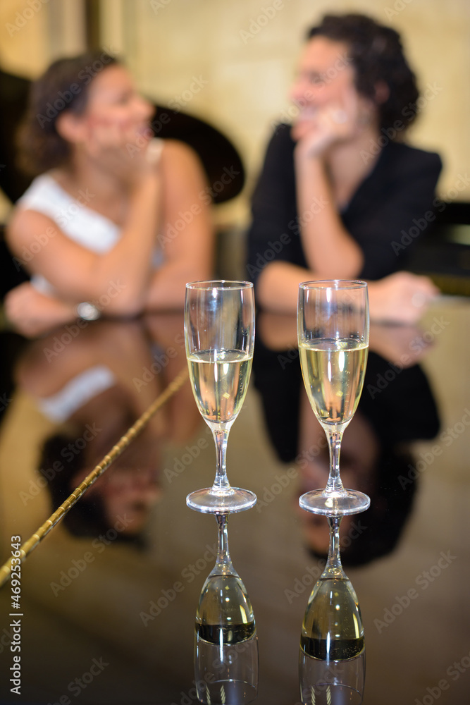 two friends and a glass of champagne