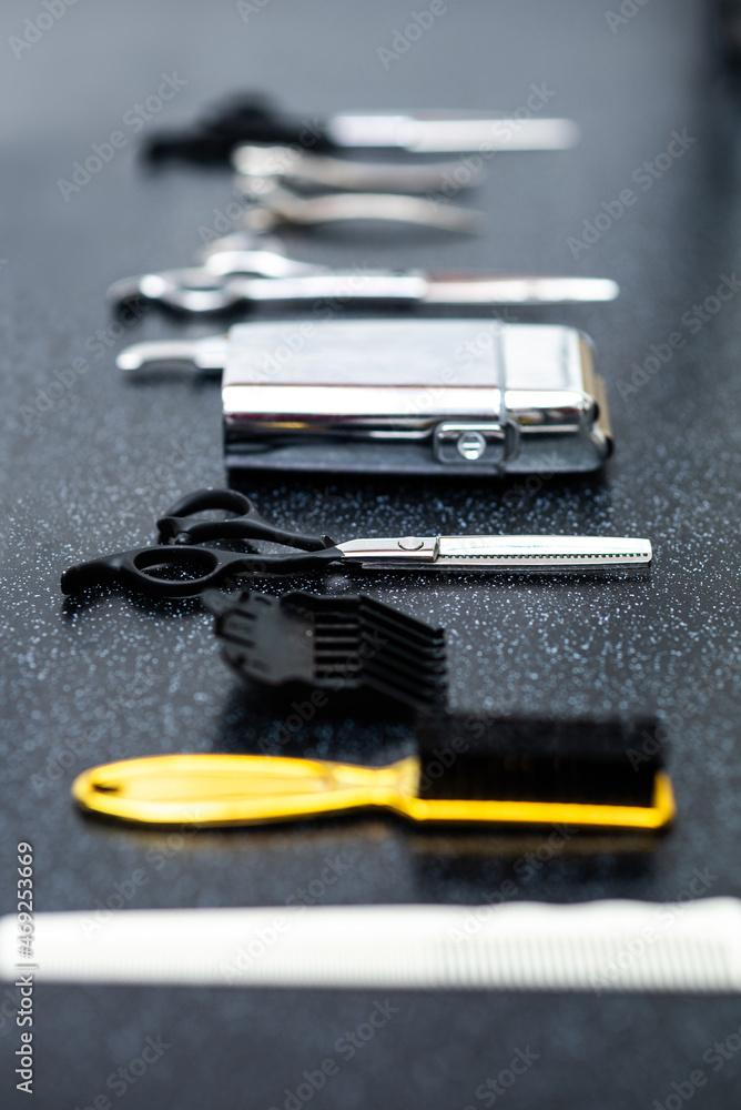 Set of professional instruments of men barber hair stylist on the table waiting to be used in work Set of professional instruments of men barber hair stylist on the table waiting to be used in work