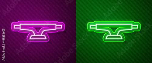 Glowing neon line Skateboard wheel icon isolated on purple and green background. Skateboard suspension. Skate wheel. Vector