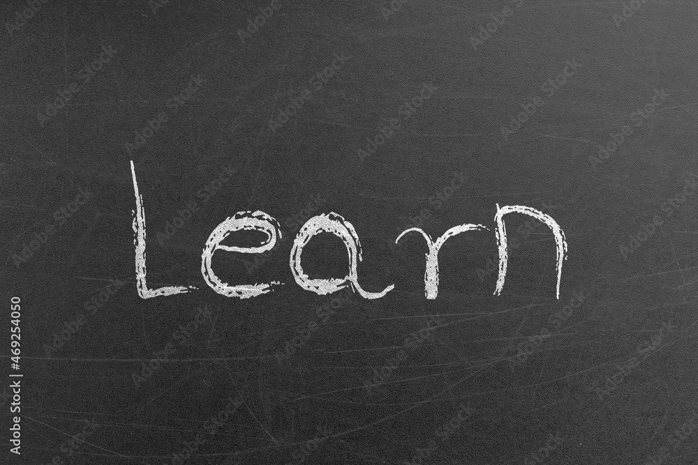 Obraz premium Learn advertisement word drawn by chalk on a school blackboard before an exam. Education and teaching concepts and backgrounds