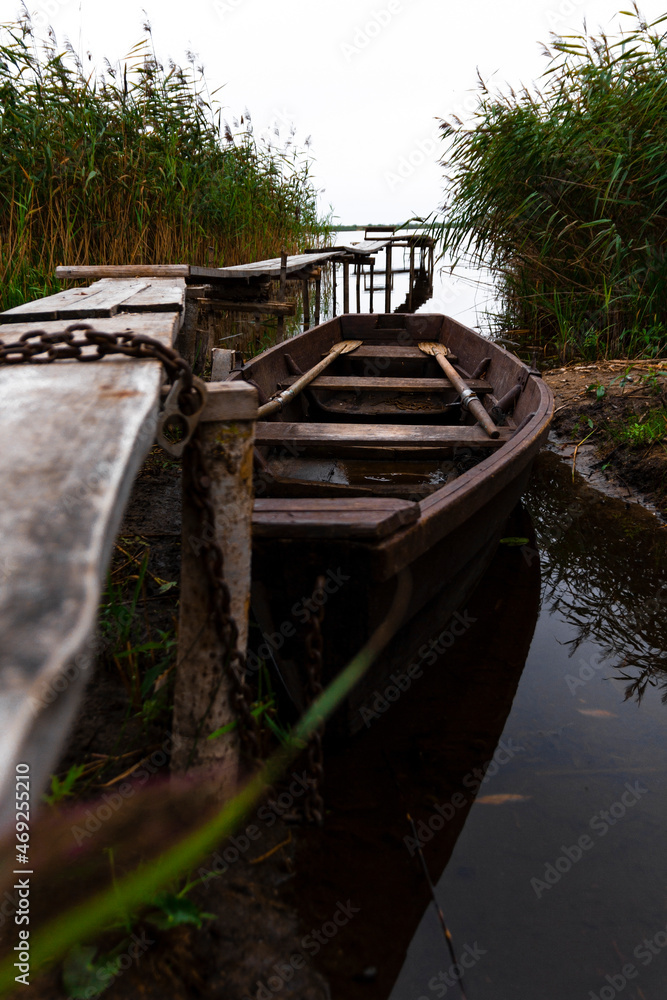 wooden boat on the water near the shore wooden boat on the water near the shore