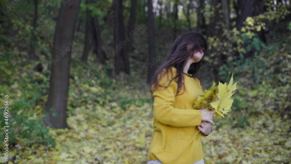 girl walking in the autumn park with yellow fallen leaves, relaxation and outdoor recreation colorful background, forest walk in October. girl walking in the autumn park with yellow fallen leaves, relaxation and outdoor recreation colorful background, forest walk in October.