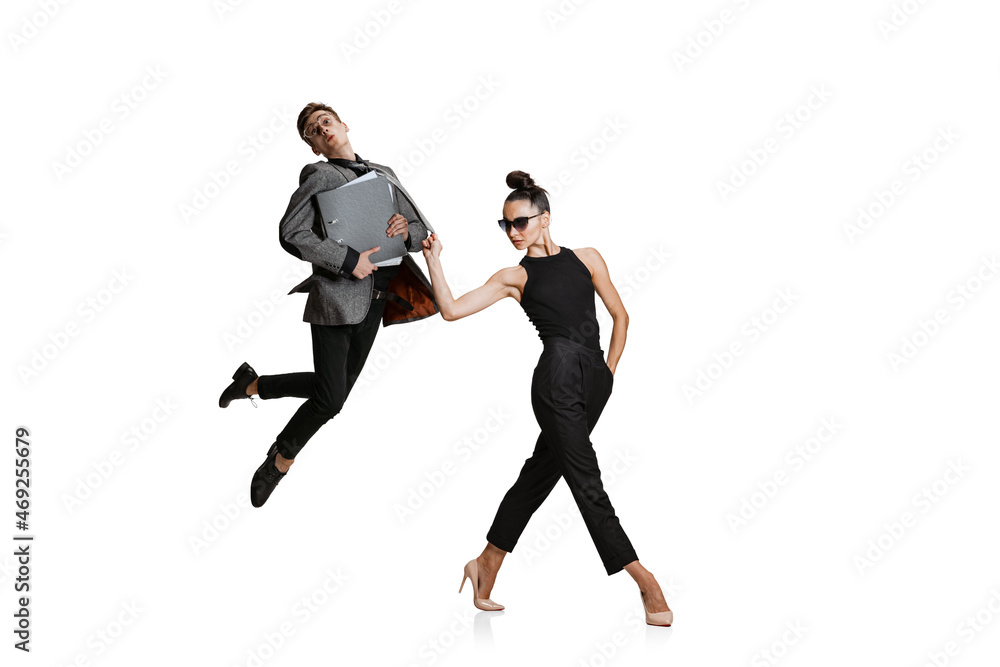 Two stylish office workers in business suits in action isolated on white background. Art, beauty, fashion and business concept Two stylish office workers in business suits in action isolated on white background. Art, beauty, fashion and business concept