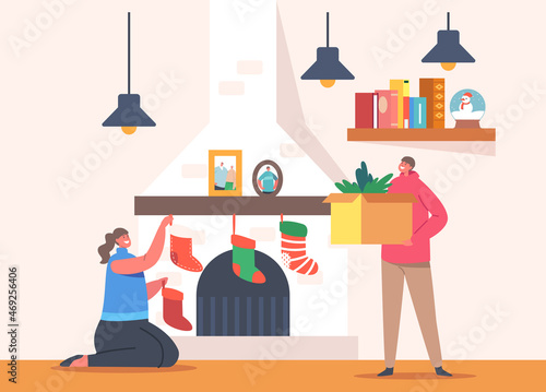 Happy Family Decorating Room on Christmas Holidays. Girl and Boy Decorate Fire Place with Fir Tree Branches, Socks