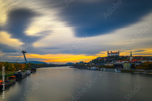 Sunset over Bratislava castle, Danube river and the SNP bridge in Slovakia