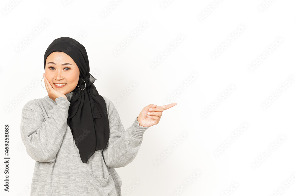 Pointing aside of Beautiful Asian Woman Wearing Hijab Isolated On White Background Pointing aside of Beautiful Asian Woman Wearing Hijab Isolated On White Background