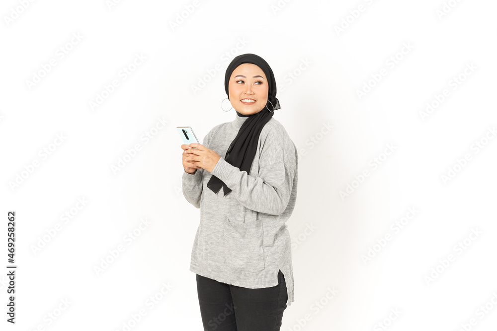 Smile and Using Smartphone of Beautiful Asian Woman Wearing Hijab Isolated On White Background Smile and Using Smartphone of Beautiful Asian Woman Wearing Hijab Isolated On White Background