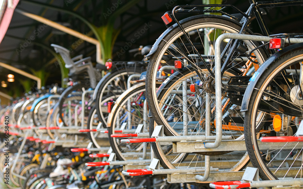 Bicycles multi-storey parking in front of a train station. Alternative transportation. Eco-friendly way to travel in city. Great for the environment. Bicycles multi-storey parking in front of a train station. Alternative transportation. Eco-friendly way to travel in city. Great for the environment.