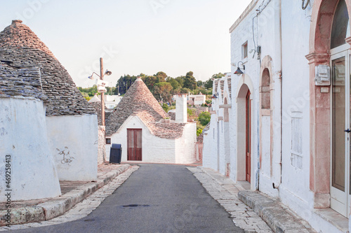 white traditional southern italian trulli village houses with tapered stone roofs