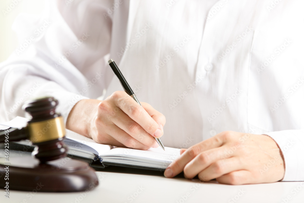 Lawyer working with contract papers and wooden gavel on tabel in courtroom. justice and law ,attorney, court judge concept. Lawyer working with contract papers and wooden gavel on tabel in courtroom. justice and law ,attorney, court judge concept.