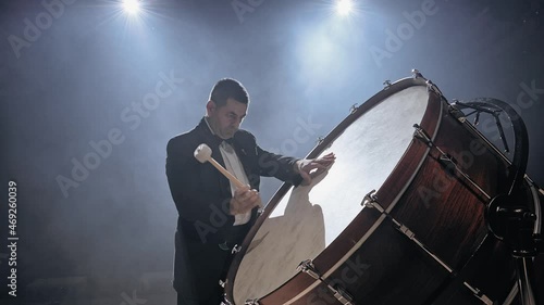 Drummer playing a bass drum in a concer