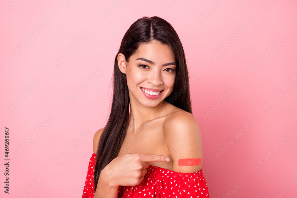 Photo of cute millennial lady point plaster wear red blouse isolated on pastel pink color background Photo of cute millennial lady point plaster wear red blouse isolated on pastel pink color background