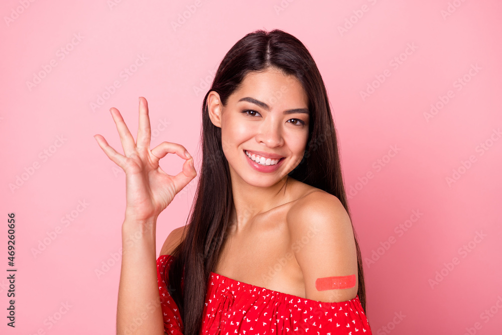 Photo of sweet millennial lady show okey sign have plaster wear red blouse isolated on pastel pink color background Photo of sweet millennial lady show okey sign have plaster wear red blouse isolated on pastel pink color background