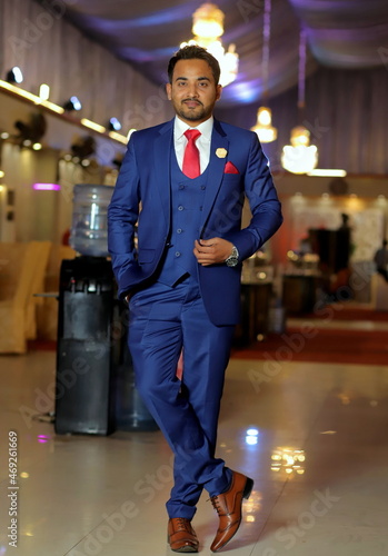 Men in blue suit with red tie photo