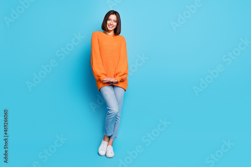 Full length body size view of attractive cheerful cute girl posing isolated over bright blue color background