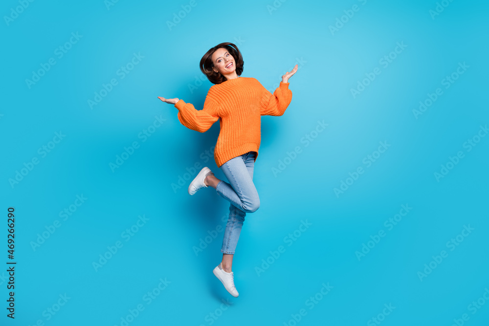 Full length body size view of attractive cheerful girl jumping having fun rest isolated over bright blue color background