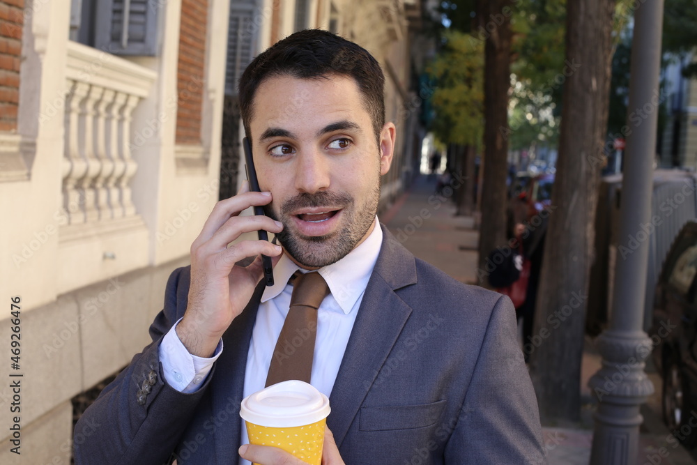Surprised businessperson on the phone outdoors Surprised businessperson on the phone outdoors
