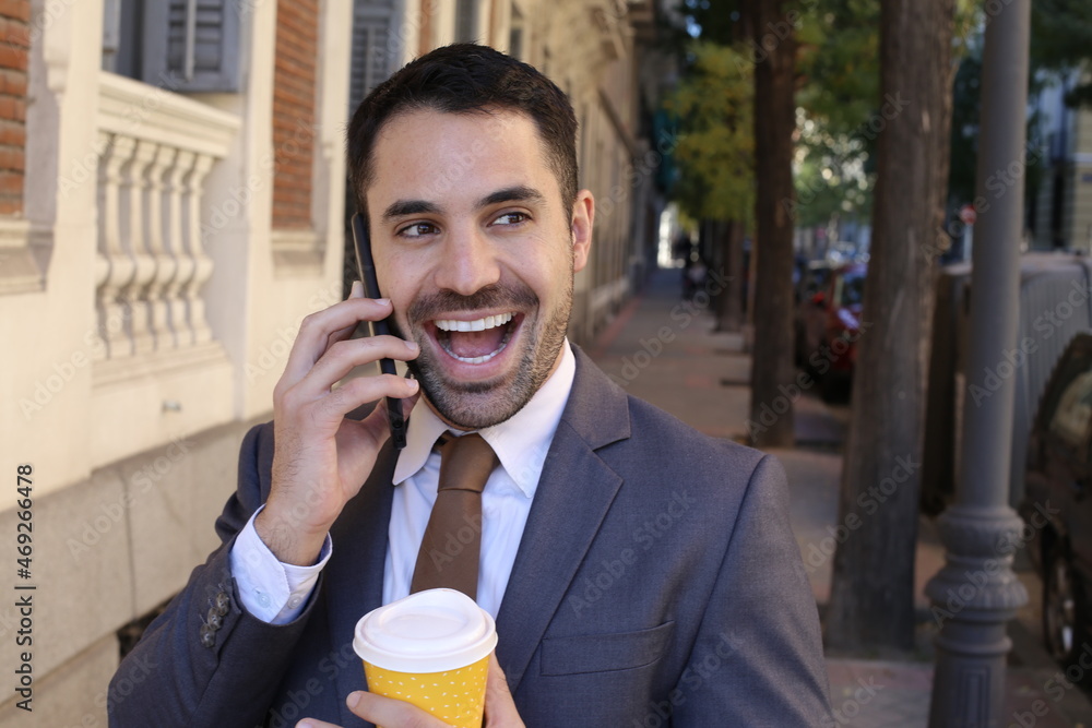 Businessman getting great news on the phone Businessman getting great news on the phone
