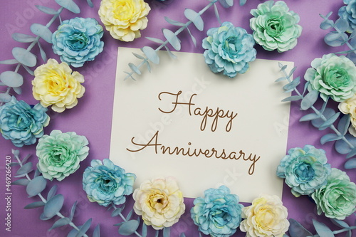 Happy Anniversary typography text and flower decorate on purple background
