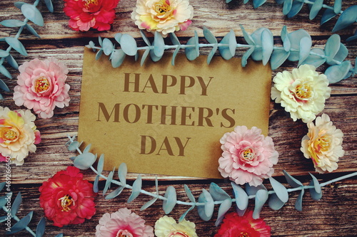 Fototapeta Naklejka Na Ścianę i Meble -  Happy Mother's Day text with flowers frame decorate on wooden background