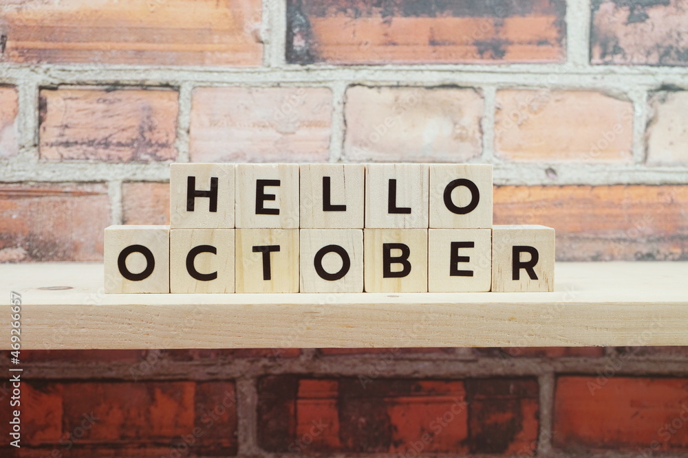 Hello October alphabet letter on shelves wooden background Hello October alphabet letter on shelves wooden background