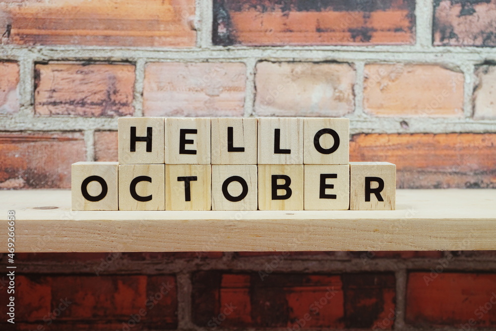 Fototapeta premium Hello October alphabet letter on shelves wooden background