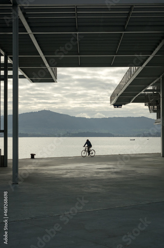 Cyclist under the pillars of El Centro Botin (Santander).